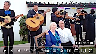 image of couple being serenaded by Mariachi band.